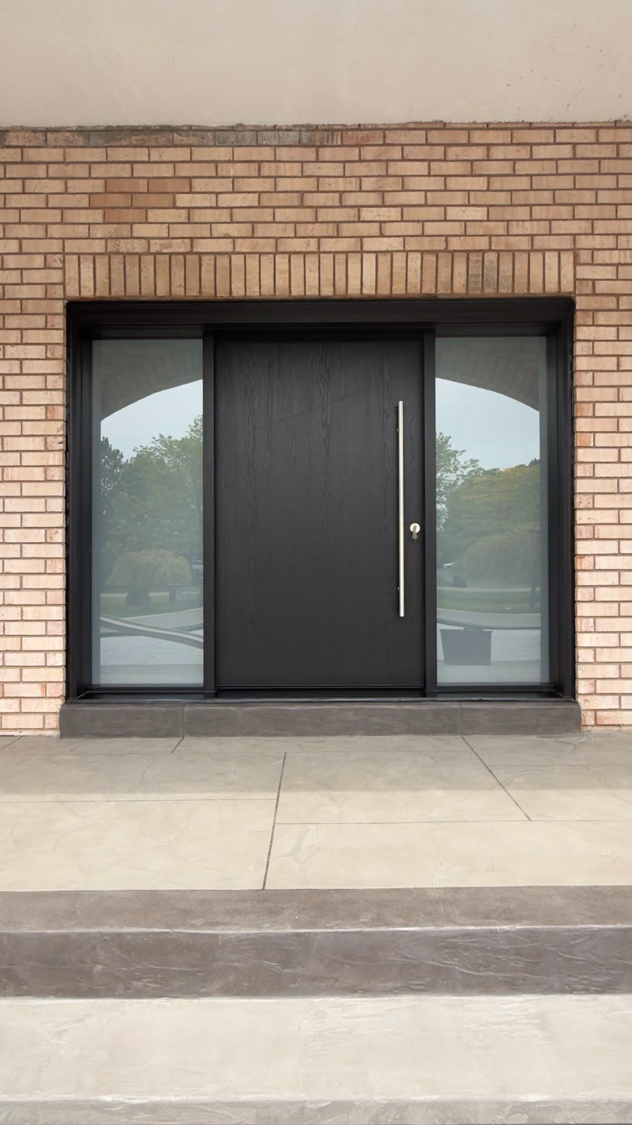 Black contemporary entry door with wide glass sidelights